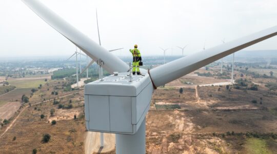 Worker on wide turbine. | Newsreel