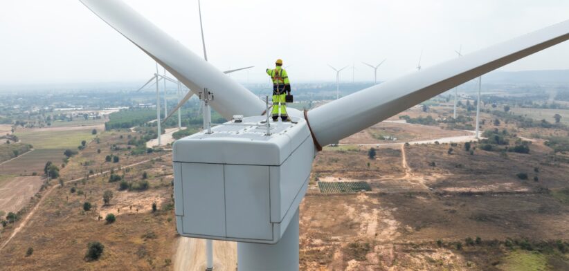 Worker on wide turbine. | Newsreel