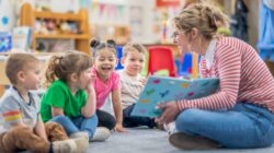 Child care worker with children in centre. | Newsreel