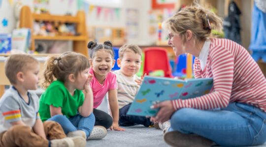 Child care worker with children in centre. | Newsreel