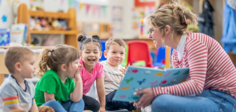 Child care worker with children in centre. | Newsreel