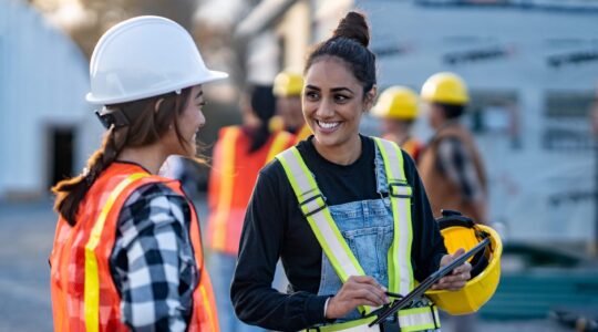 Two women on a construction site. | Newsreel