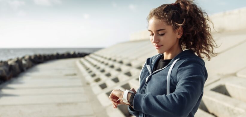 Woman checking wearable activity tracker. | Newsreel