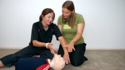 Teacher and student in first aid course. | Newsreel