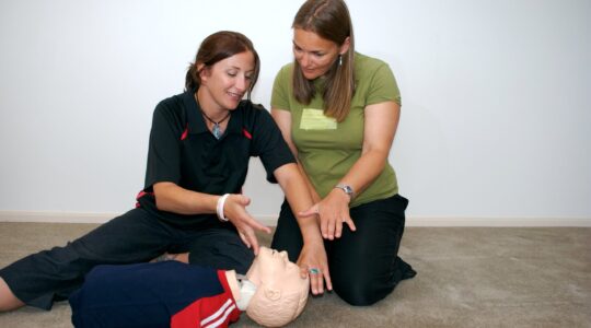 Teacher and student in first aid course. | Newsreel