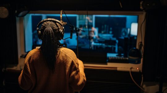 Singer in recording studio. | Newsreel