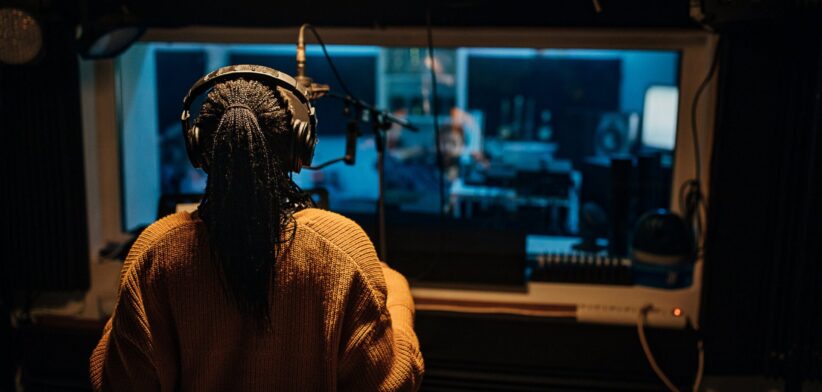 Singer in recording studio. | Newsreel