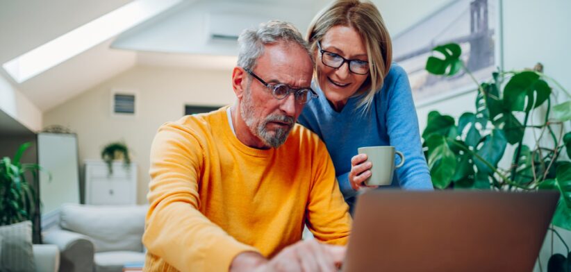 Elderly couple looking at computer. | Newsreel