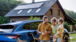 Family with electric car and solar panels on home. | Newsreel