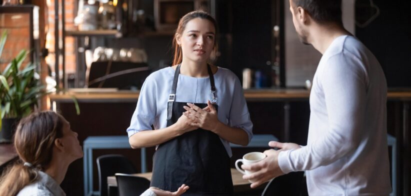 Worker being confronted by angry customers