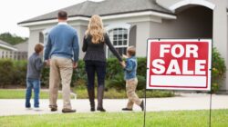 Family outside home for sale. | Newsreel