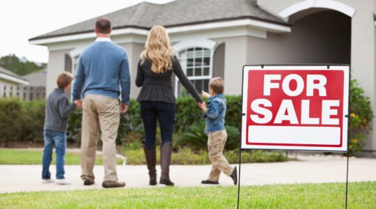 Family outside home for sale. | Newsreel