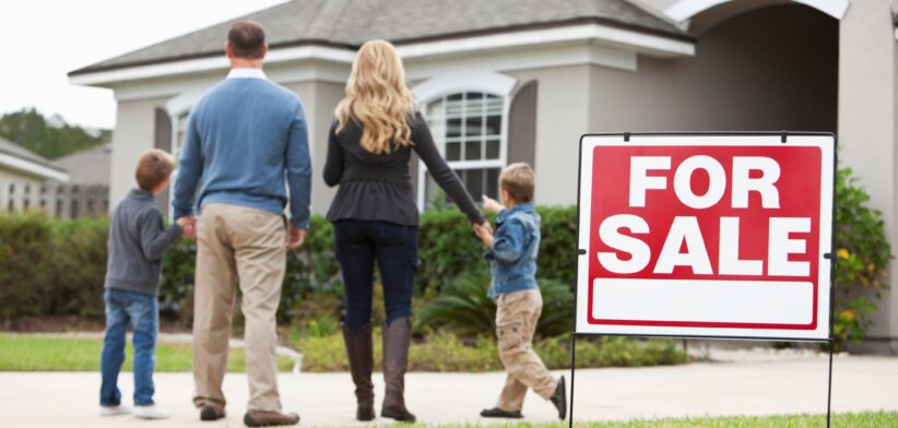 Family outside home for sale. | Newsreel