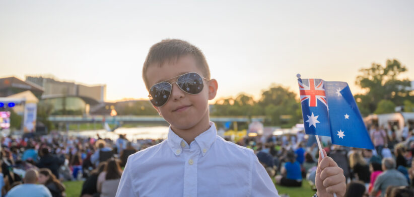 Australian kid holding a flag while celebrating Australia day