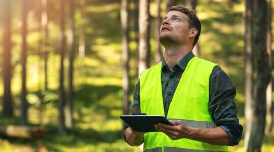 Man taking data in bush. | Newsreel