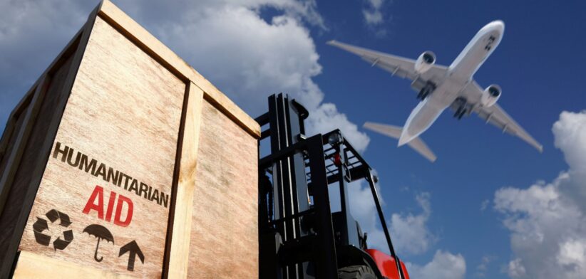 Aid shipment with plane above. | Newsreel