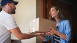 Woman receiving parcel delivery. | Newsreel