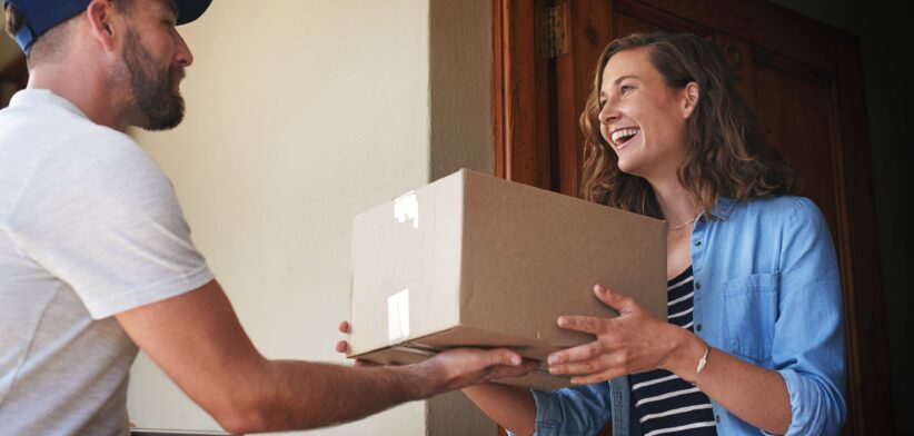 Woman receiving parcel delivery. | Newsreel