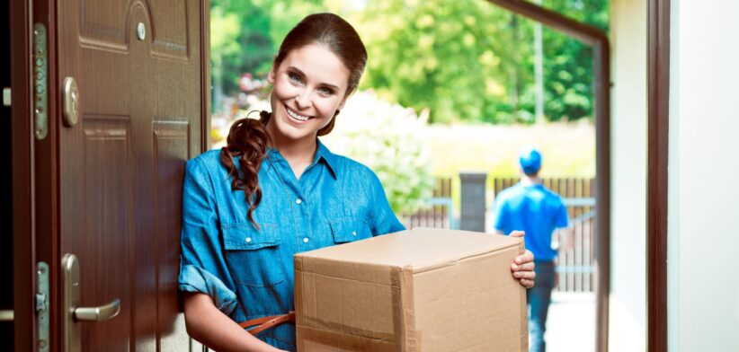 Woman after receiving a parcel delivery. | Newsreel