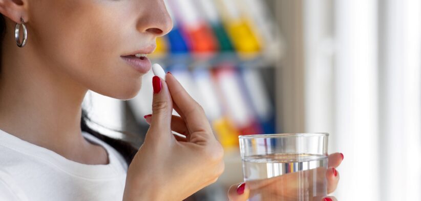 Woman taking a pill. | Newsreel