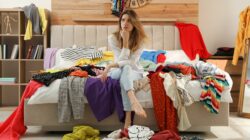 Woman surrounded by clothes. | Newsreel