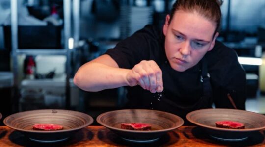 Chef working on restaurant dishes. | Newsreel