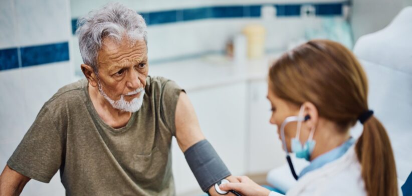 Elderly man being seen by a doctor. | Newsreel