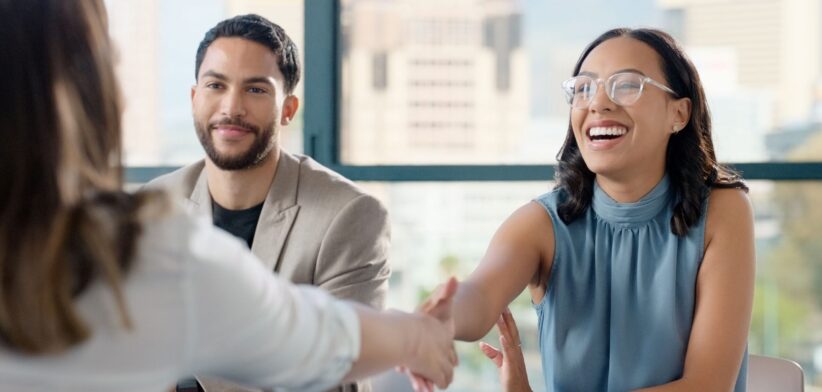 Happy woman shaking hands. | Newsreel