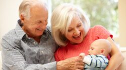 Elderly couple with baby. | Newsreel