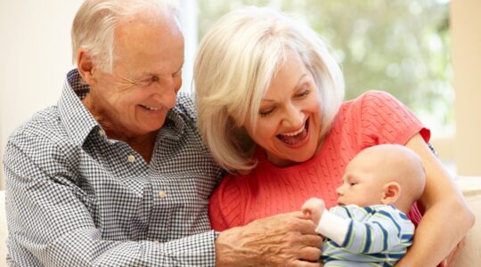 Elderly couple with baby. | Newsreel