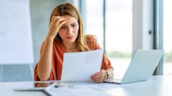 Woman confused with paperwork. | Newsreel