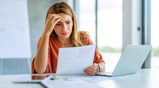 Woman confused with paperwork. | Newsreel