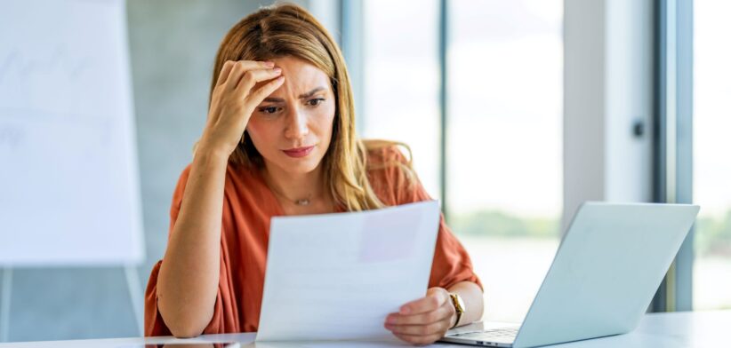 Woman confused with paperwork. | Newsreel