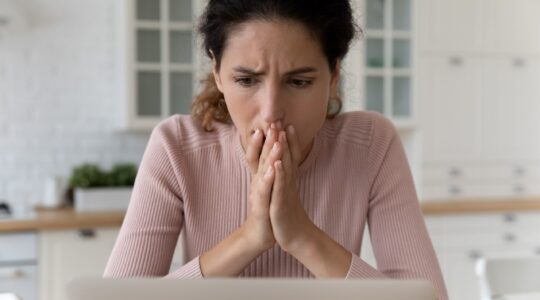 Woman worried looking at computer. | Newsreel