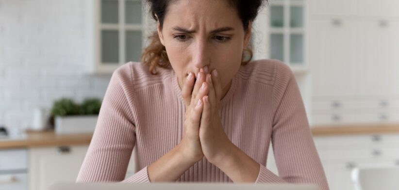 Woman worried looking at computer. | Newsreel