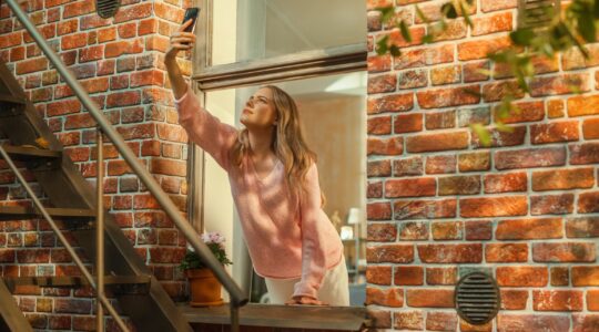 Woman trying to get signal of mobile phone. | Newsreel