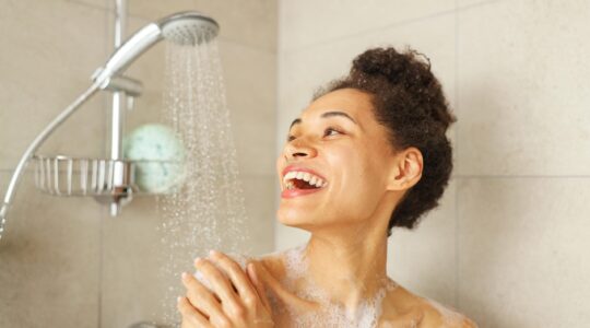 Woman having a shower. | Newsreel