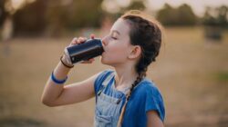 Girl drinking a soft drink. | Newsreel