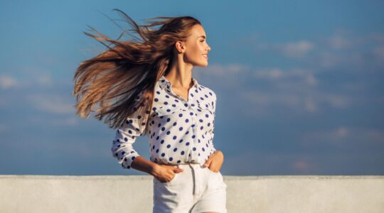 Woman with hair blowing in breeze. | Newsreel