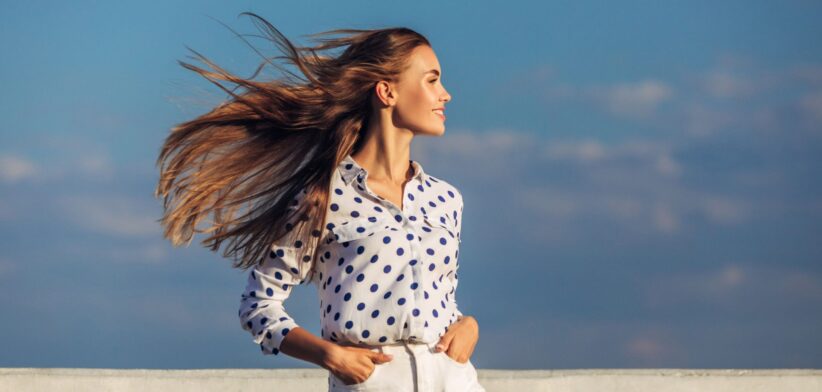 Woman with hair blowing in breeze. | Newsreel