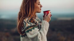 Woman in jumper with hot drink. | Newsreel