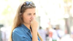 Woman holding her nose. | Newsreel