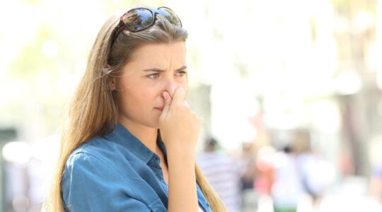 Woman holding her nose. | Newsreel