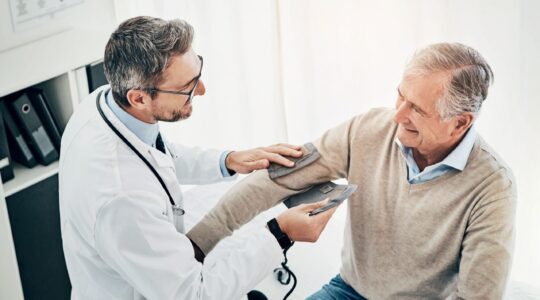 Man getting blood pressure taken. | Newsreel