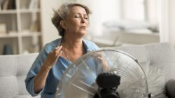 Woman using an electric fan. | Newsreel