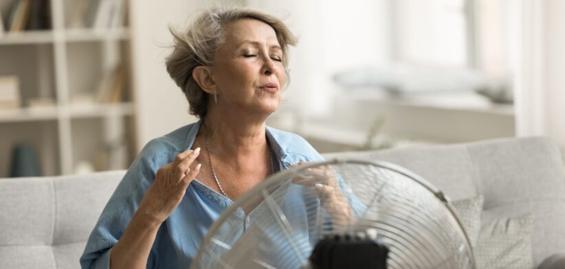 Woman using an electric fan. | Newsreel