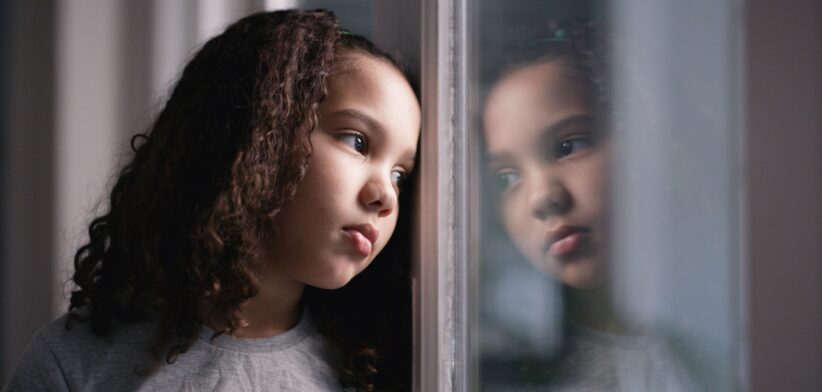 Sad girl looking out window. | Newsreel