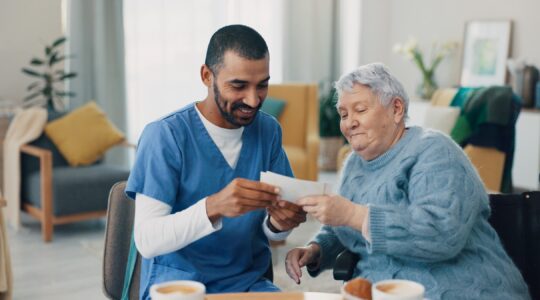 Aged care worker and elderly woman. | Newsreel