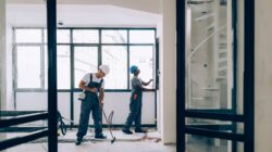 Workers building a house. | Newsreel