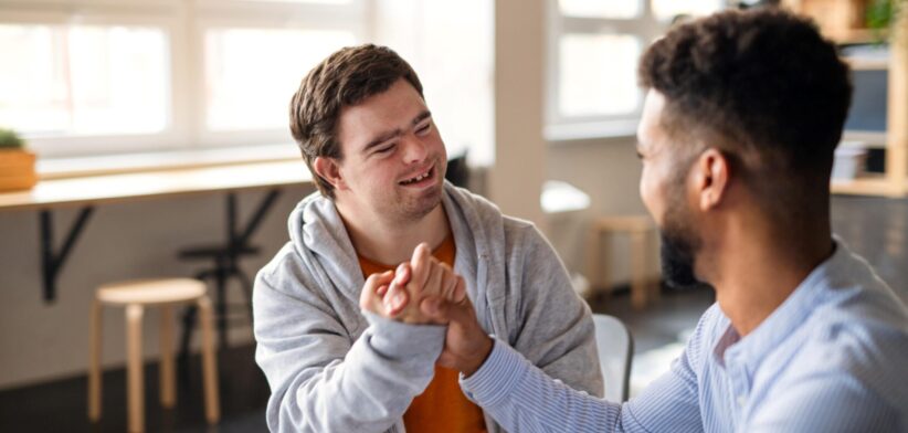 Person with disability and support worker. | Newsreel